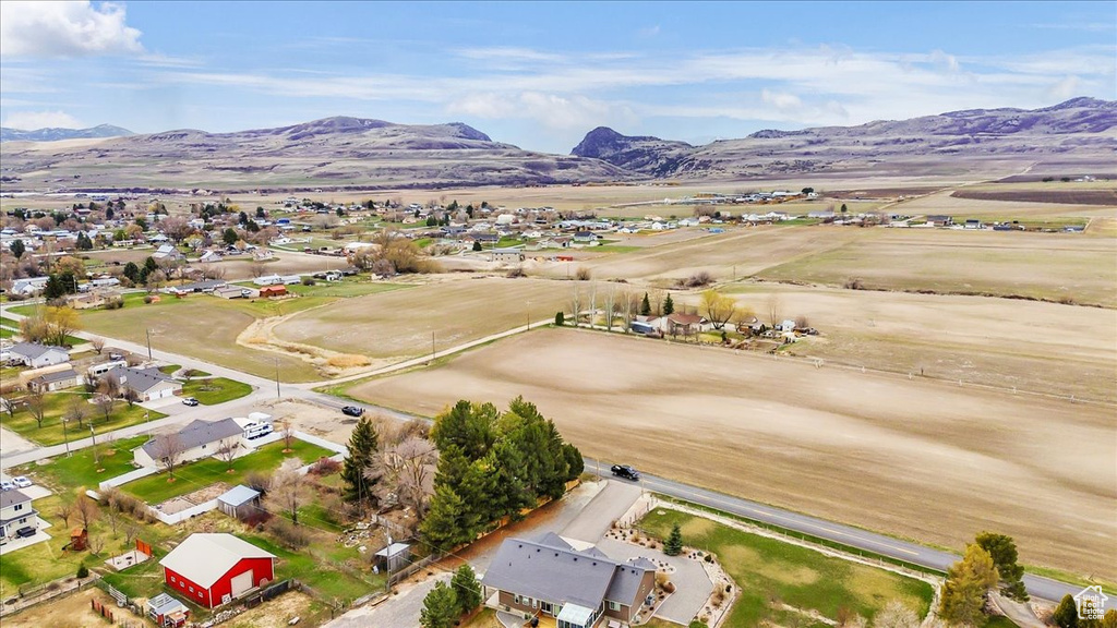Aerial overview of property\'s location featuring mountains and nearby suburban area