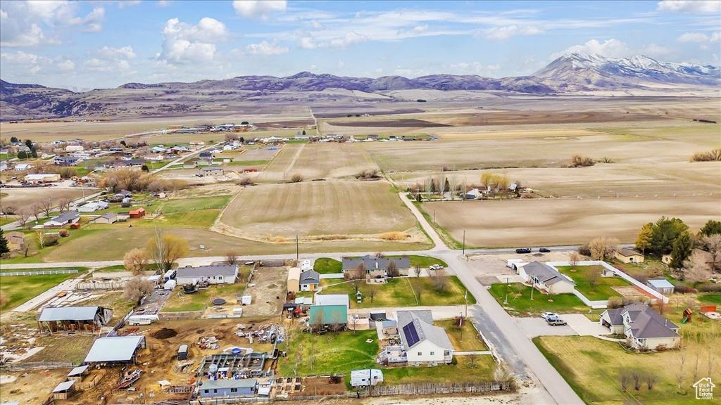 Aerial overview of property\'s location with a mountainous background and nearby suburban area