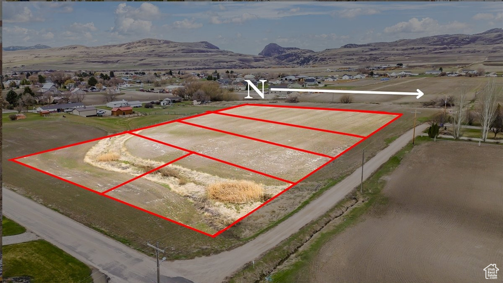 Aerial view of property\'s location featuring property parcel outlined and mountains