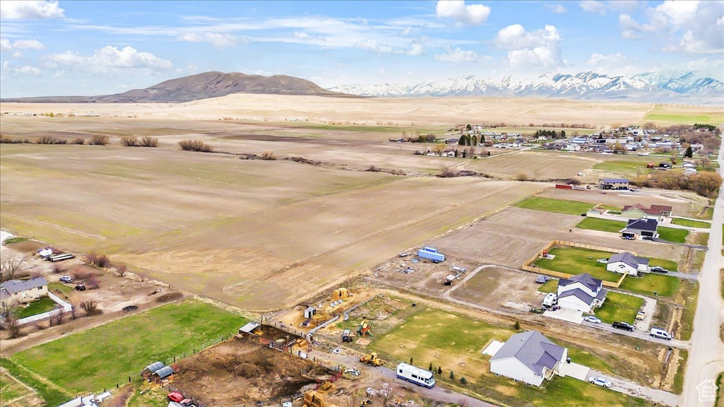 Aerial view of property and surrounding area featuring mountains