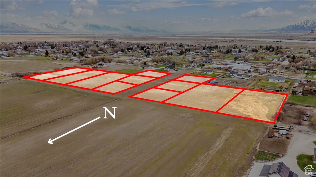 Aerial overview of property\'s location with property parcel outlined and a mountainous background