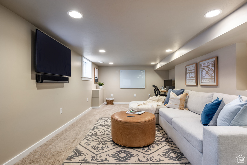 Living room featuring light colored carpet, recessed lighting, and baseboards
