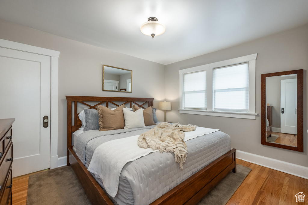 Bedroom featuring wood finished floors and baseboards