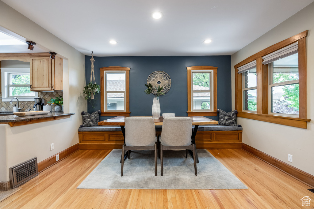 Dining space with light wood-style flooring, recessed lighting, and baseboards