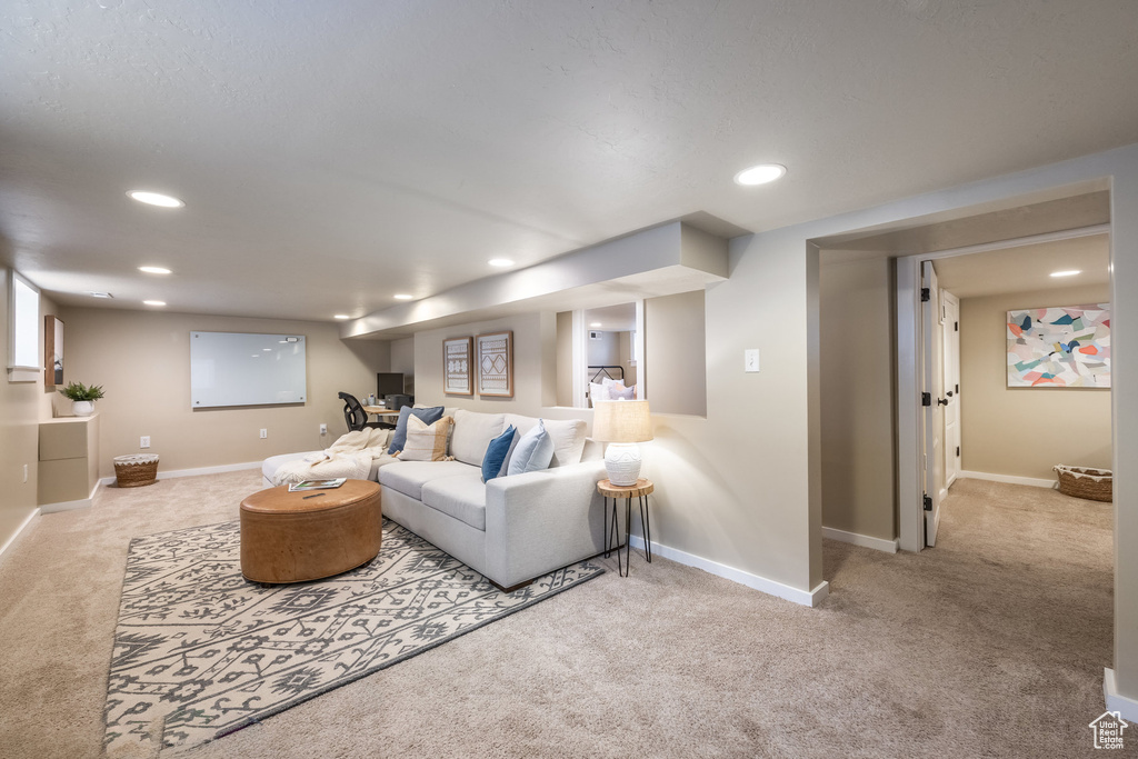 Carpeted living room with recessed lighting and baseboards