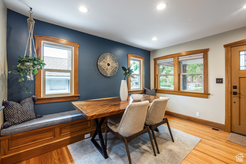 Dining room featuring healthy amount of natural light, light wood-style flooring, recessed lighting, and baseboards
