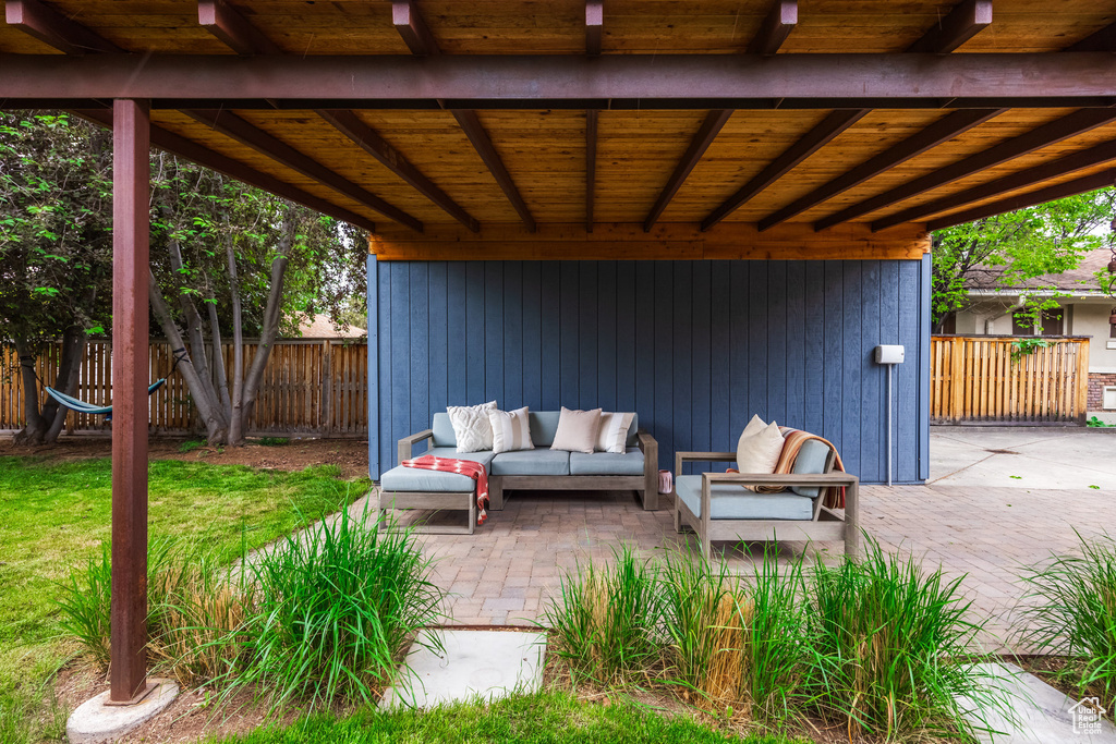 View of patio featuring an outdoor living space and fence