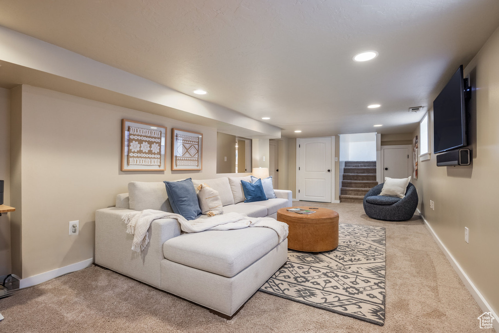 Living room with carpet, recessed lighting, baseboards, and stairs