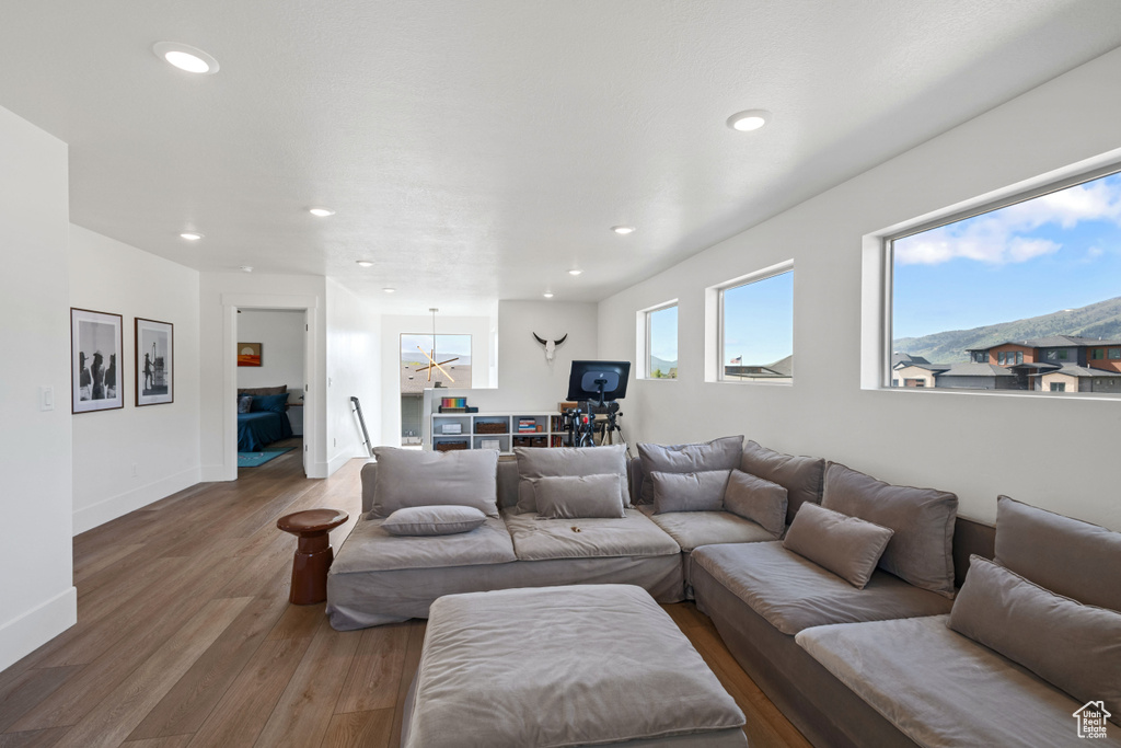 Living area featuring wood finished floors, recessed lighting, and baseboards