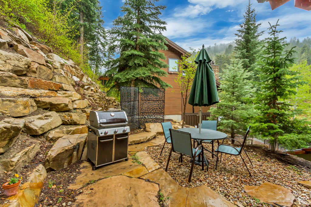 View of patio featuring area for grilling and outdoor dining space
