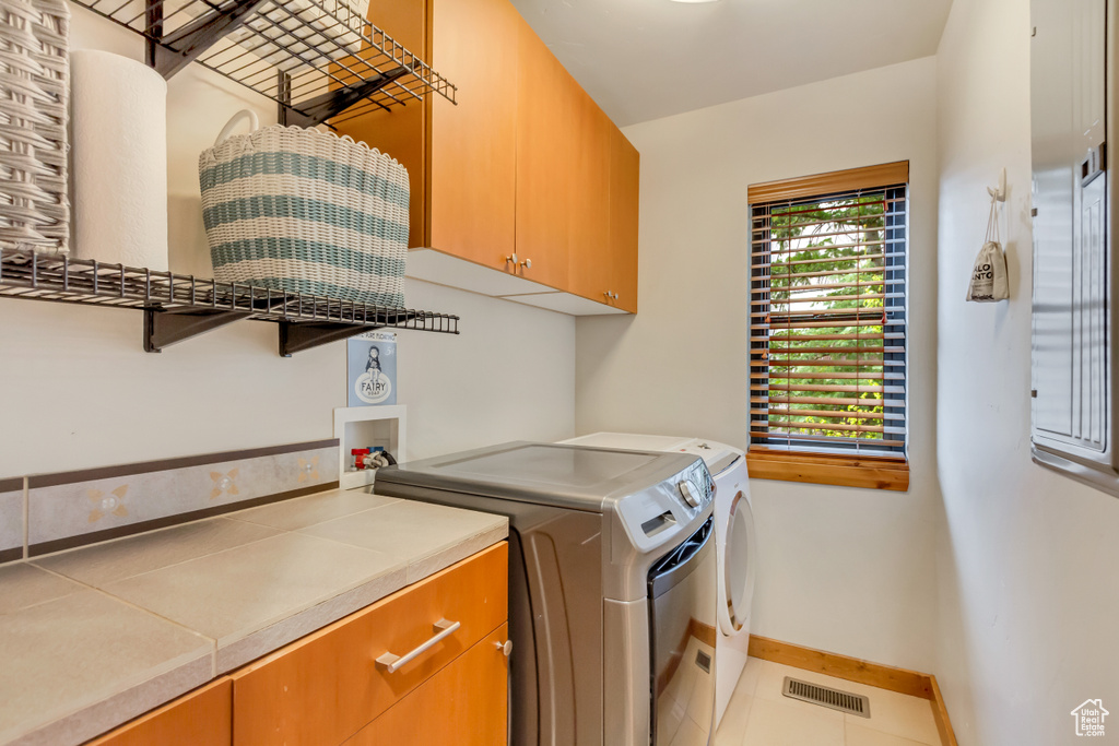 Laundry area with cabinet space, washer and clothes dryer, and baseboards