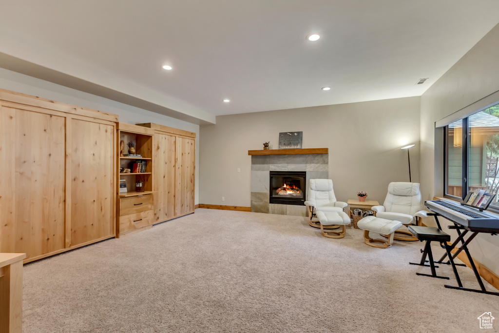 Sitting room featuring carpet floors, a tiled fireplace, recessed lighting, and baseboards