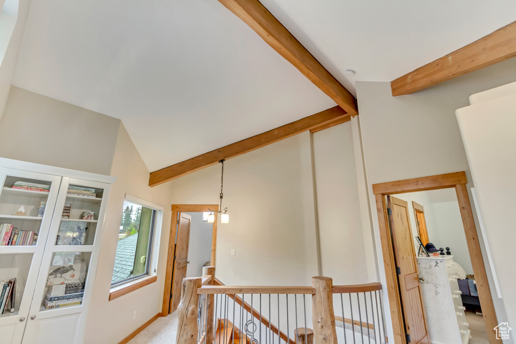 Hallway with an upstairs landing and light carpet