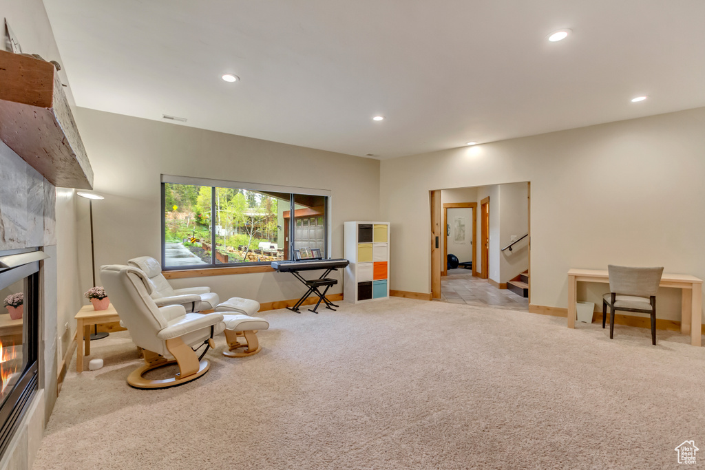 Sitting room featuring carpet, recessed lighting, baseboards, stairs, and a fireplace