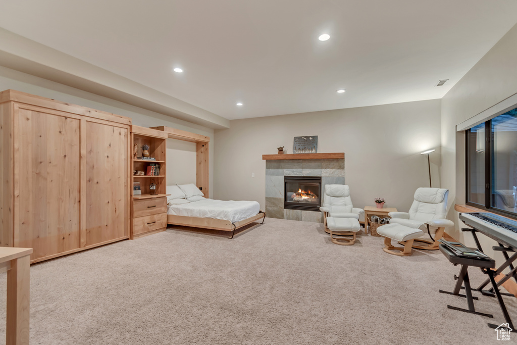 Bedroom featuring carpet, recessed lighting, and a fireplace