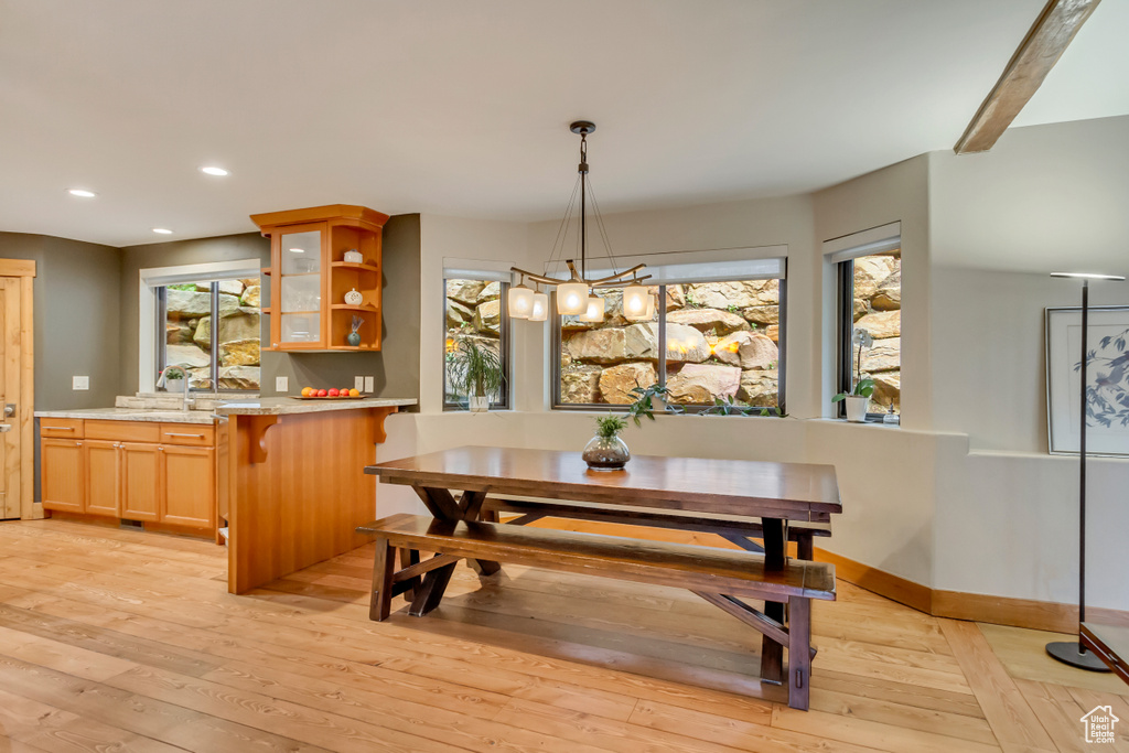 Dining space featuring light wood finished floors, a chandelier, recessed lighting, and baseboards