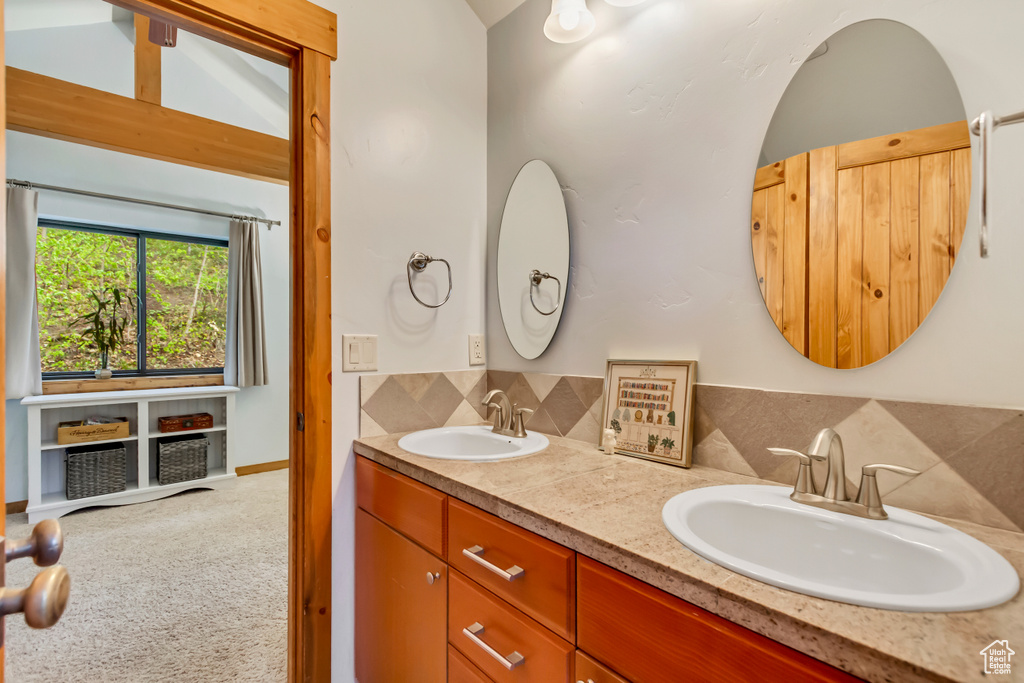 Bathroom featuring backsplash and double vanity