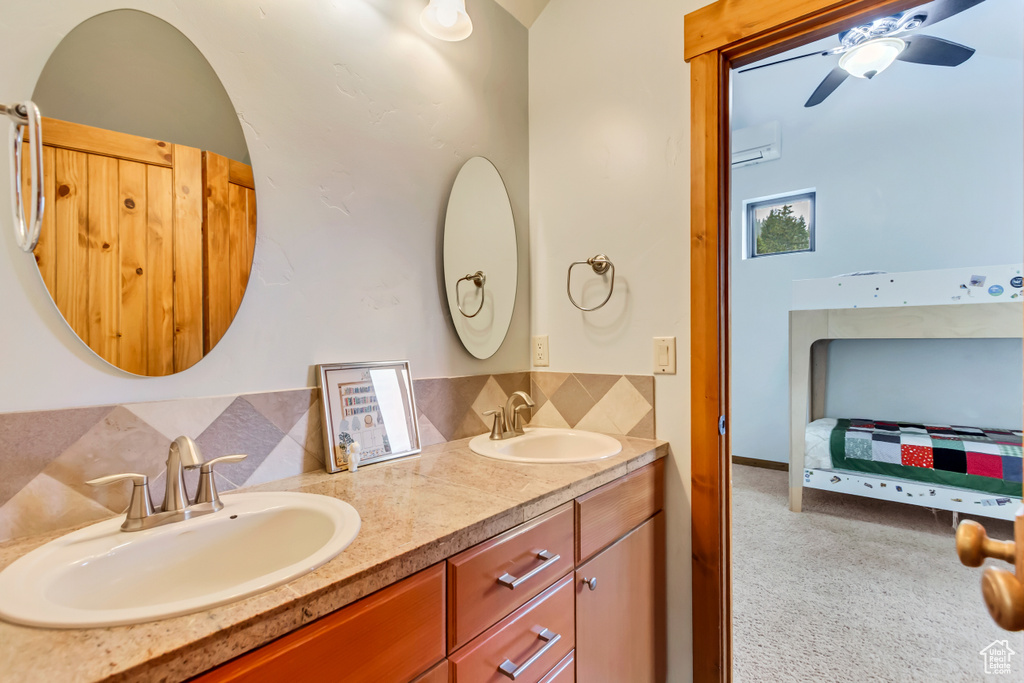 Full bathroom featuring backsplash, double vanity, and ceiling fan