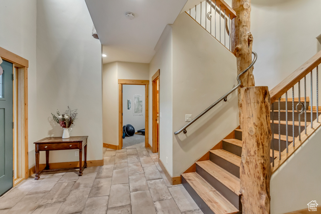 Entryway with stairway and baseboards
