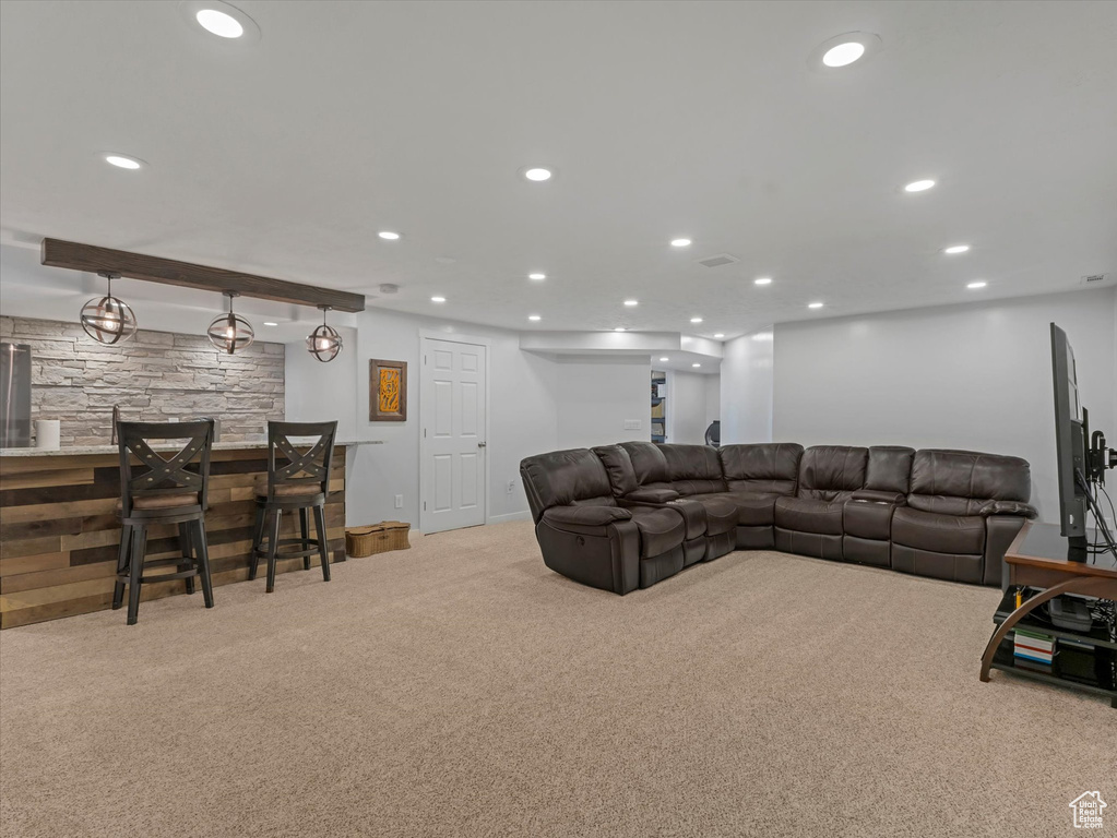 Living room featuring a bar, carpet, recessed lighting, and baseboards