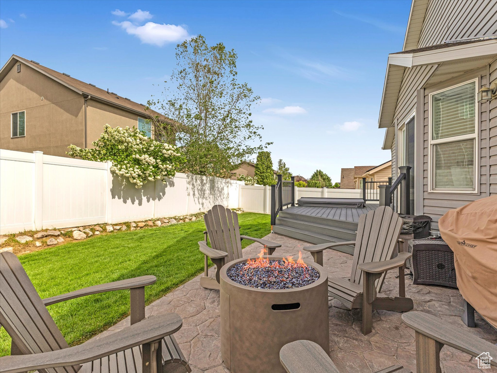 View of patio / terrace with a fire pit and a wooden deck