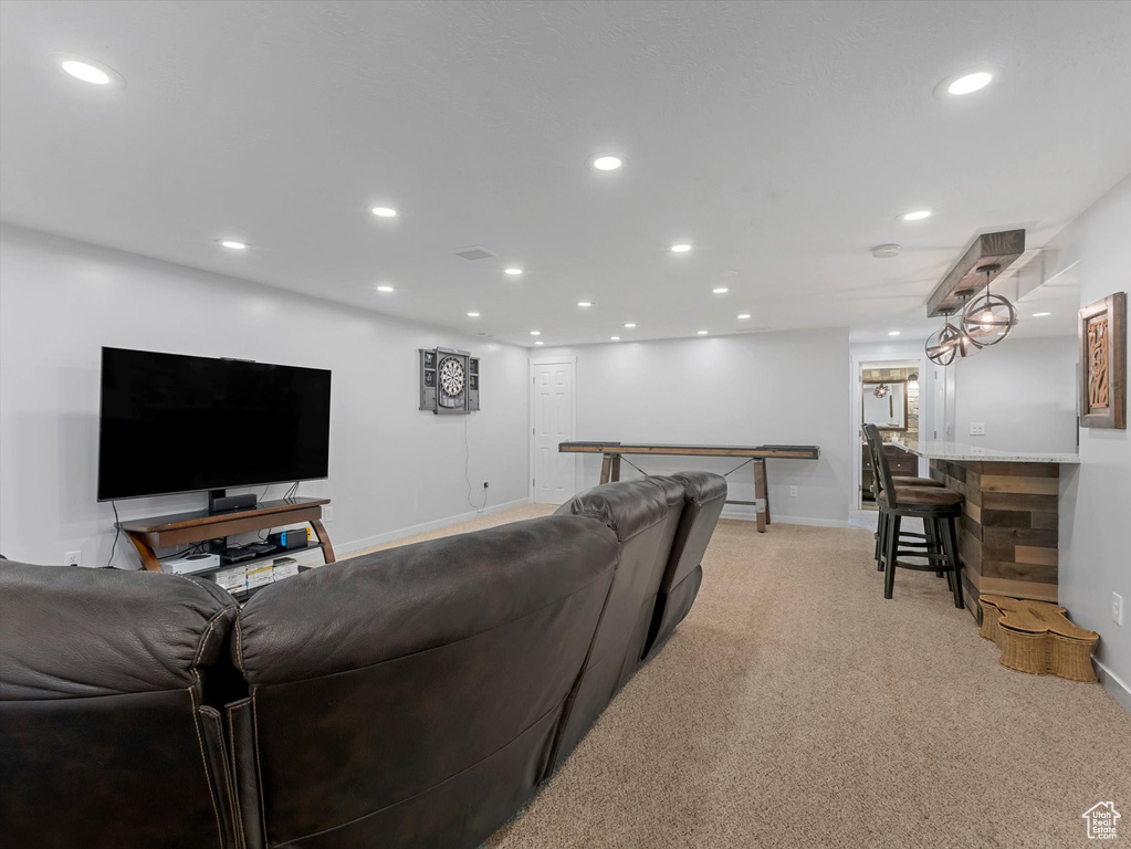 Living room featuring recessed lighting, light colored carpet, and baseboards