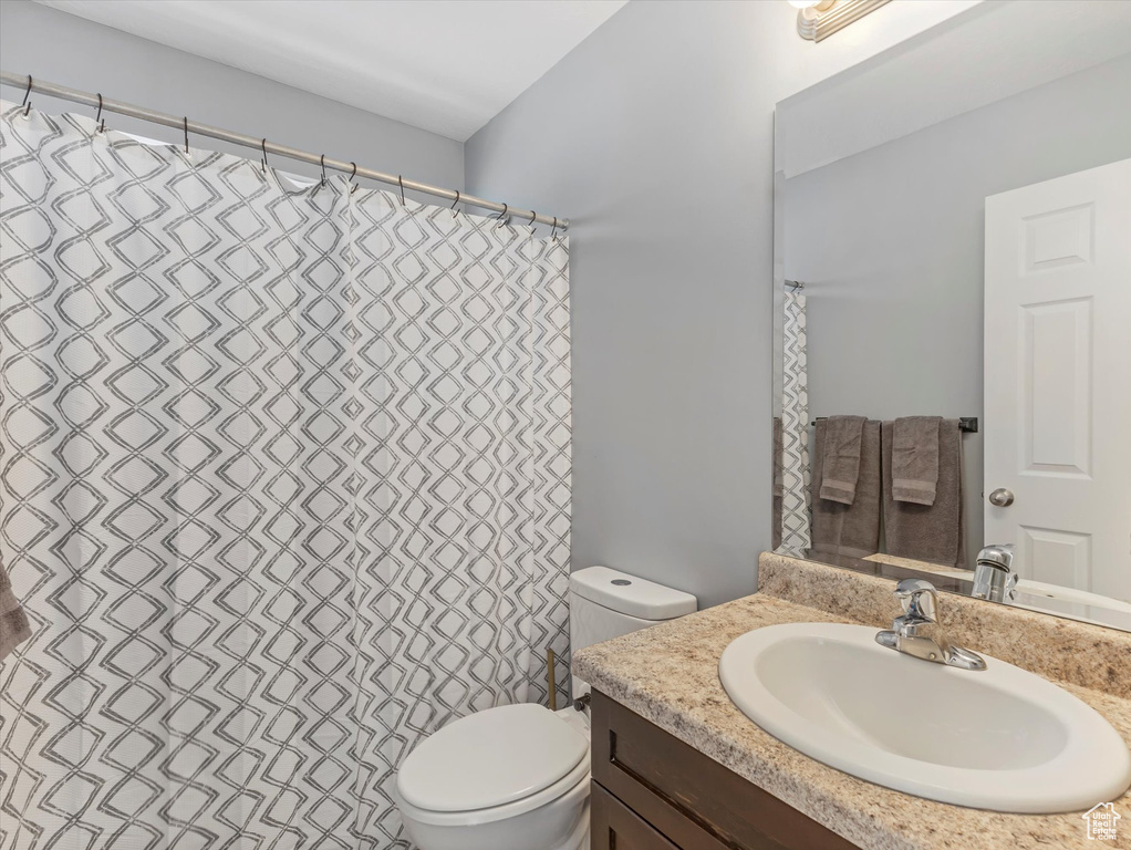 Full bathroom with toilet and vanity