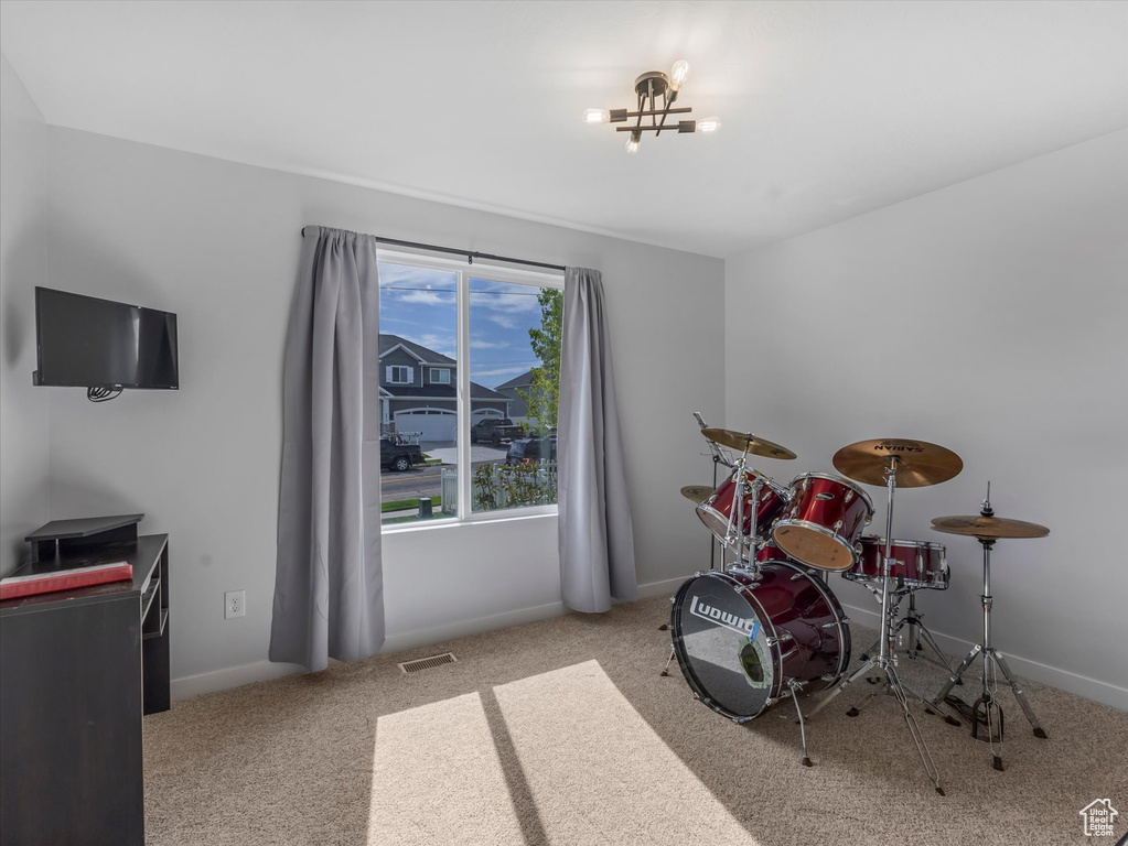 Playroom with carpet floors, baseboards, and a chandelier