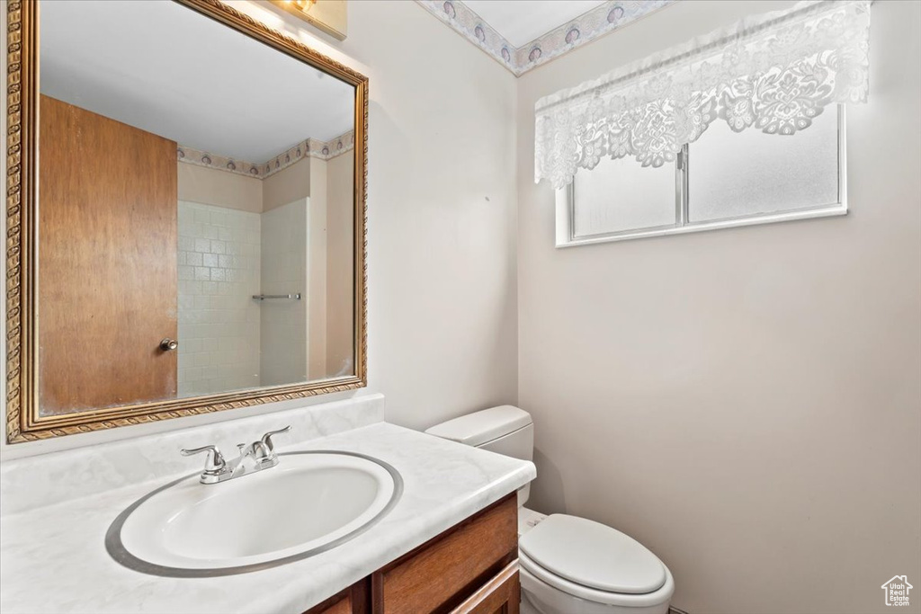 Full bathroom with toilet and vanity