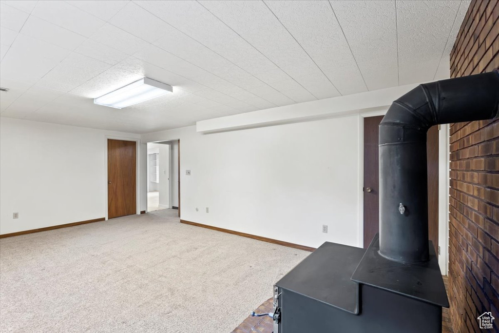 Unfurnished living room featuring carpet and baseboards