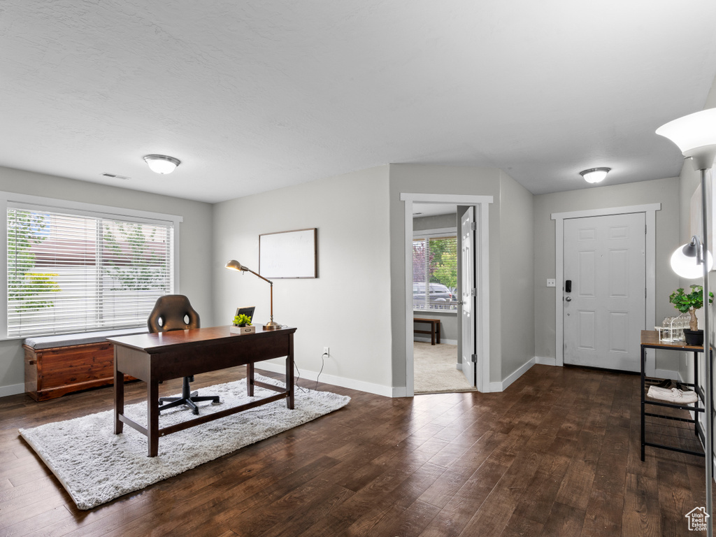 Office space with dark wood finished floors and baseboards