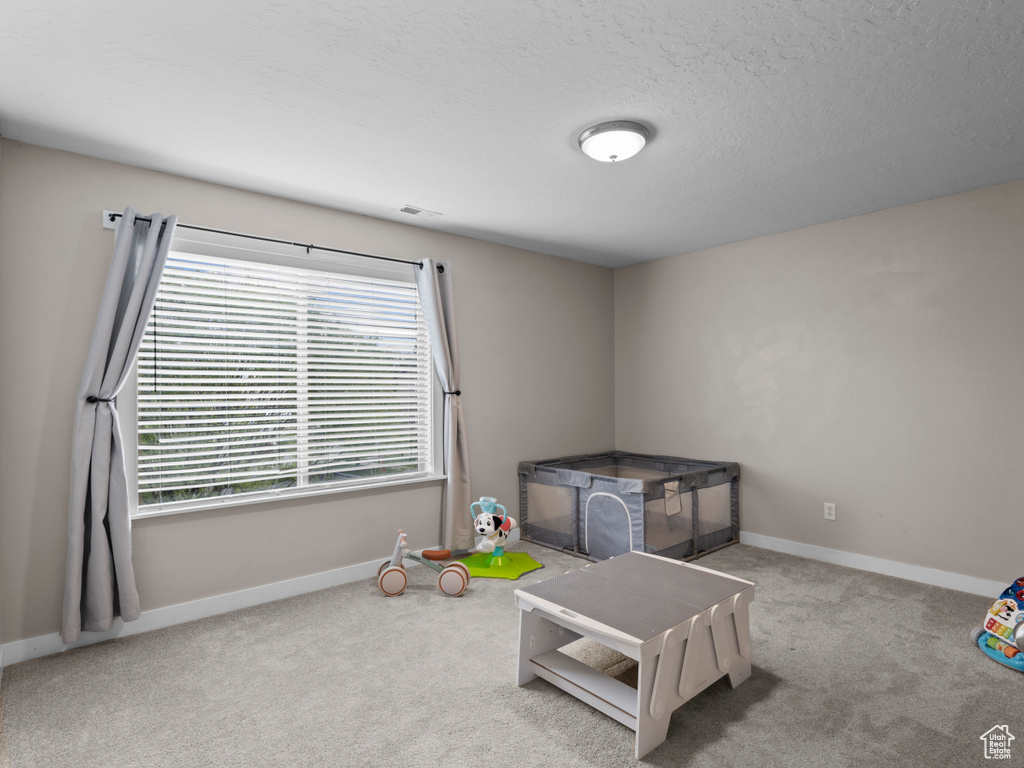 Playroom with carpet floors and baseboards
