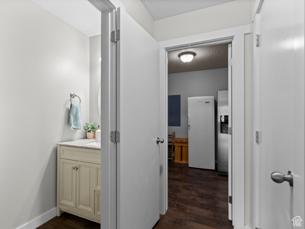 Corridor with dark wood-style floors and electric panel