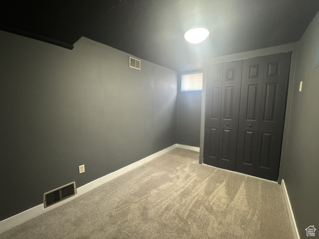 Unfurnished bedroom featuring carpet floors, a closet, and baseboards