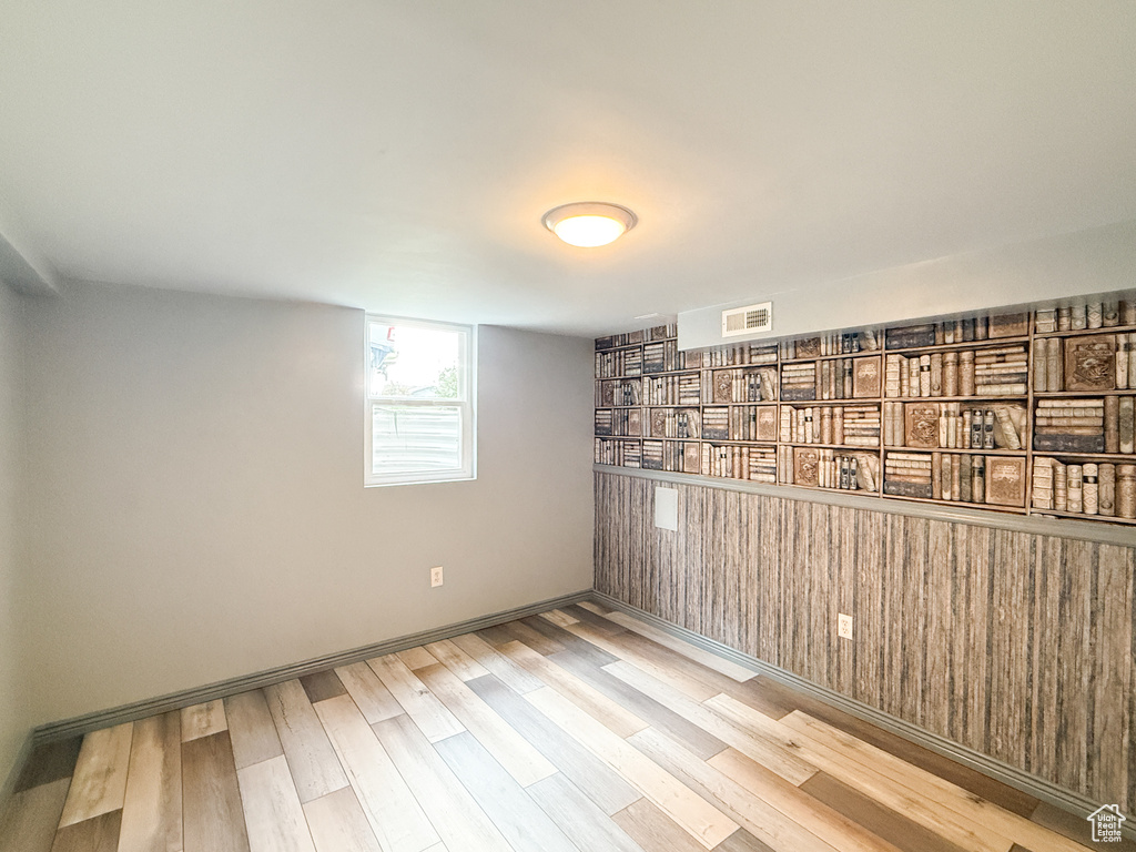 Below grade area featuring wood finished floors and baseboards
