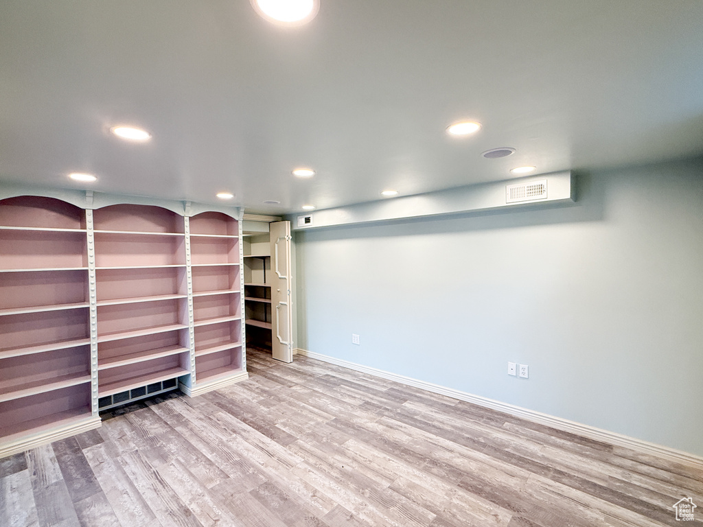 Finished below grade area with wood finished floors, recessed lighting, and baseboards