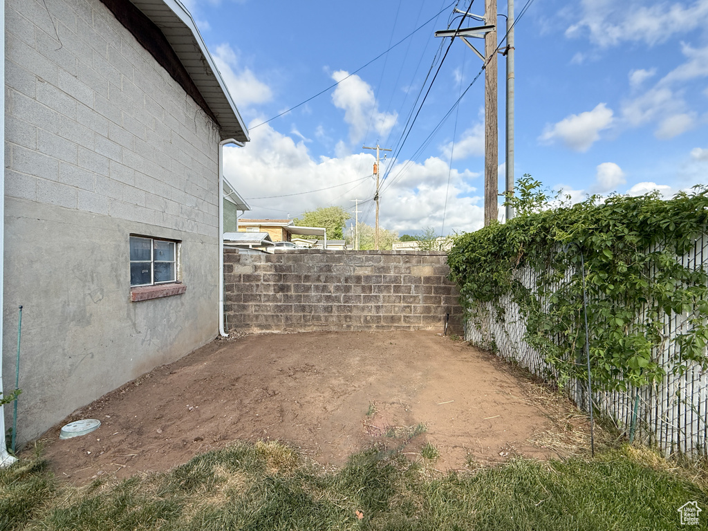 View of yard featuring fence and a patio area