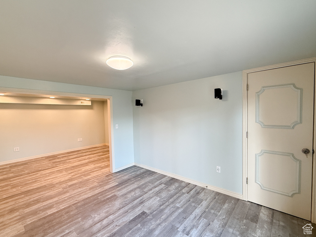 Spare room featuring wood finished floors and baseboards