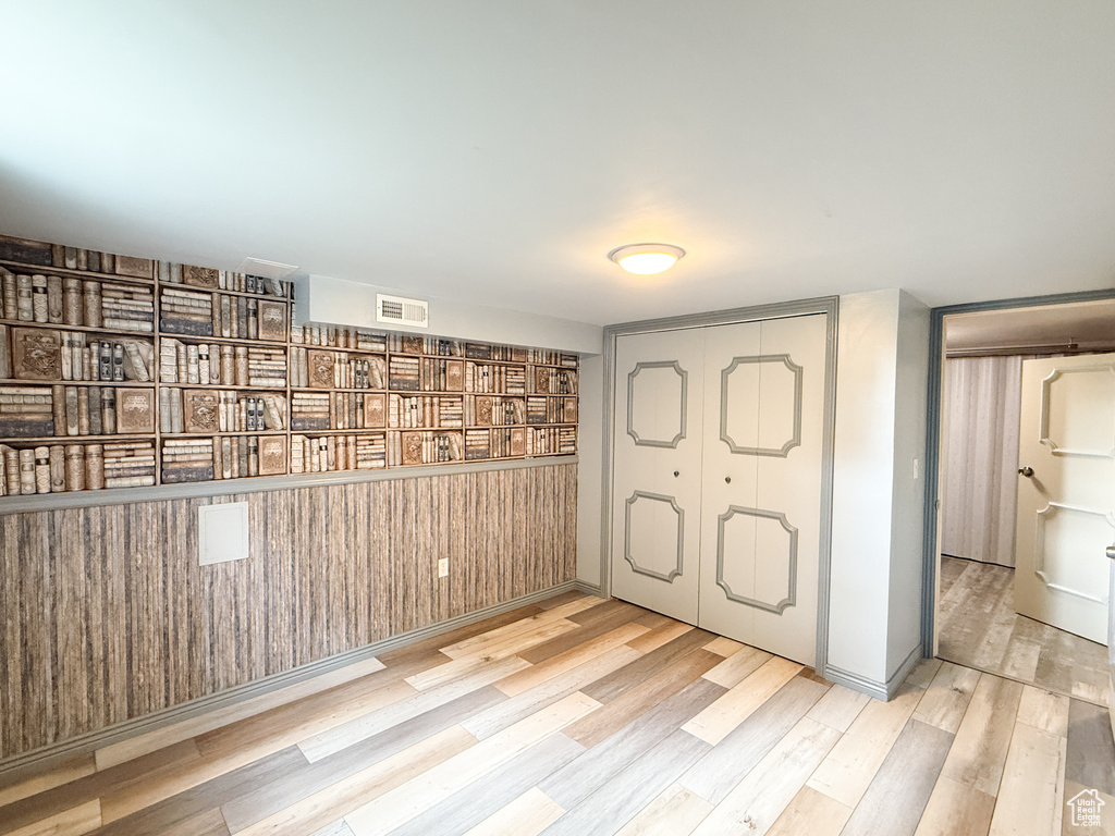 Unfurnished bedroom featuring wood finished floors and a closet