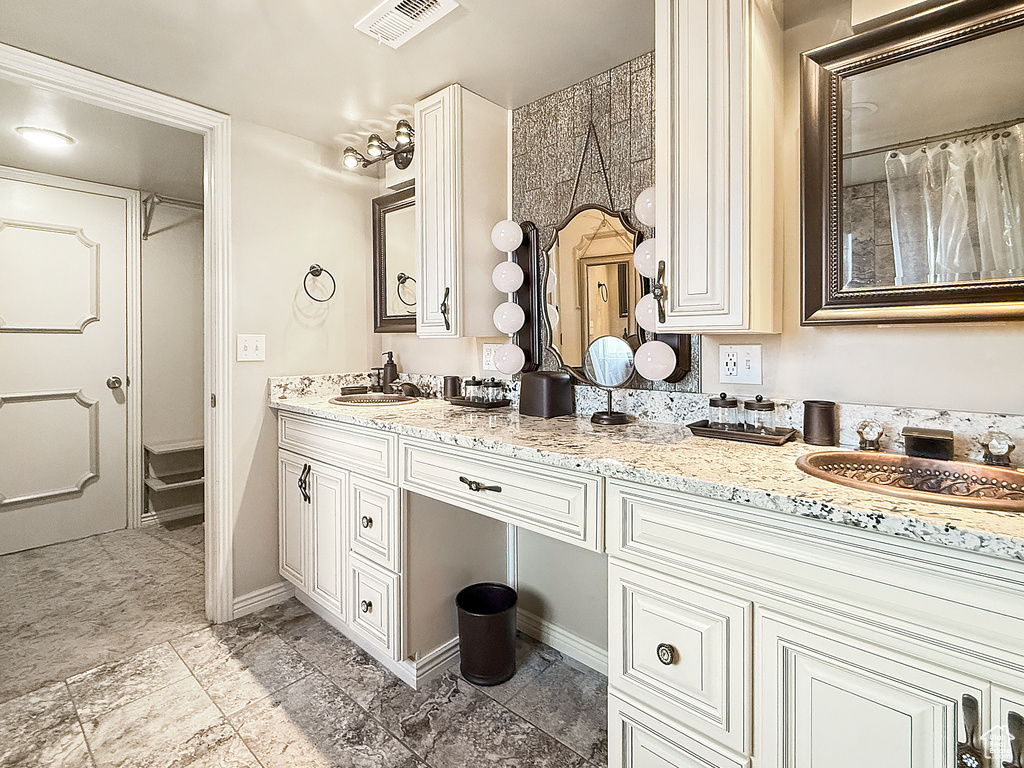 Full bathroom featuring double vanity