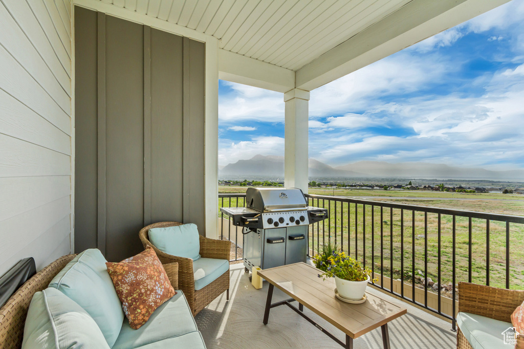 Balcony with a grill, a mountain view, and an outdoor living space