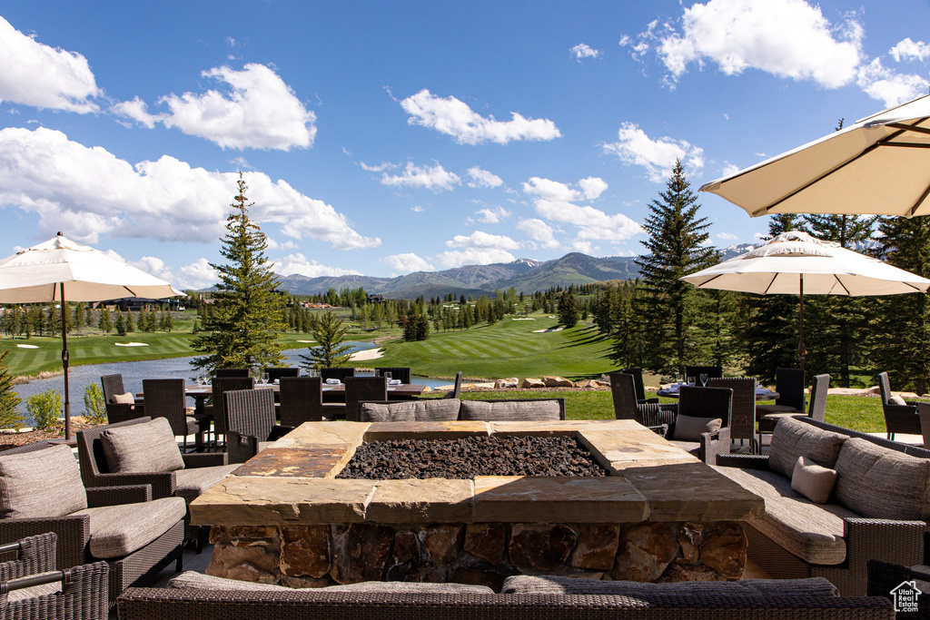 View of patio / terrace featuring a mountain view, golf course view, and an outdoor living space with a fire pit