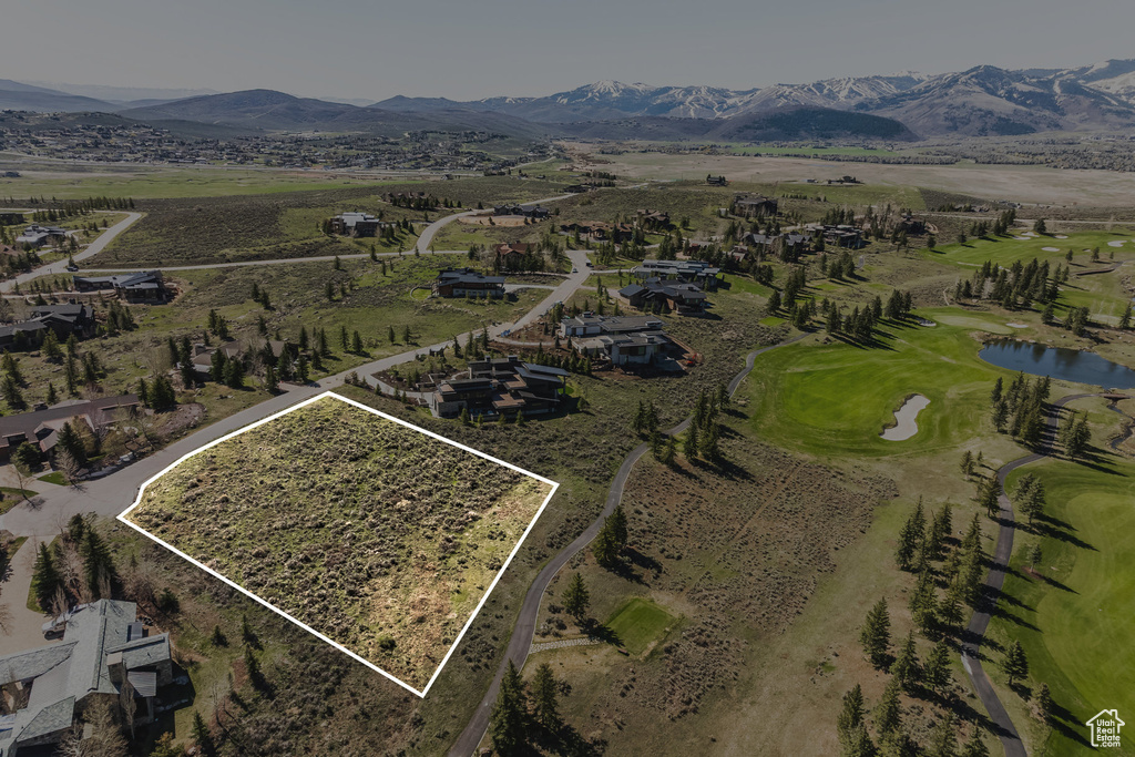 Aerial view of property\'s location with a water and mountain view and property parcel outlined