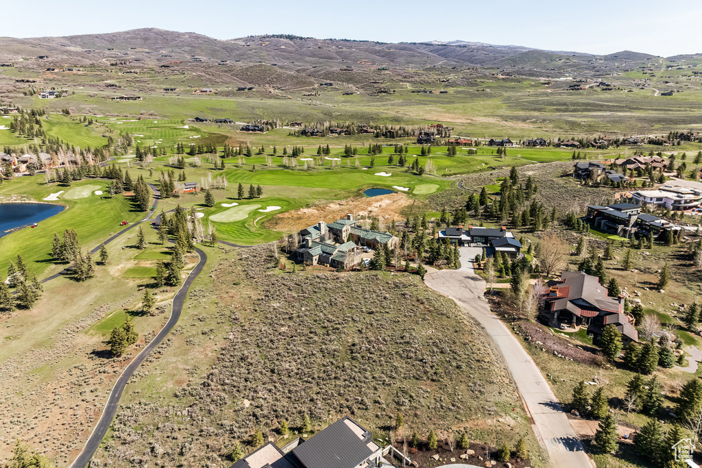 Aerial overview of property\'s location with a local golf course and a water and mountain view