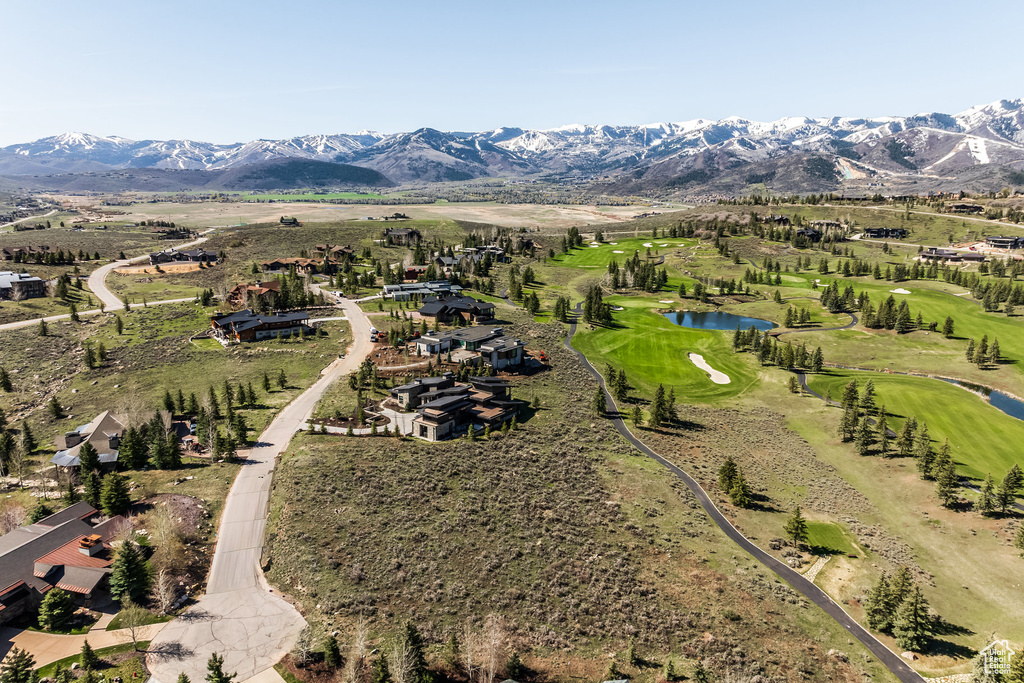 View of property location featuring a water and mountain view and a local golf course