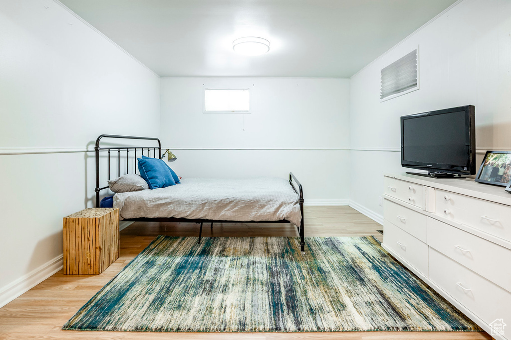 Bedroom featuring light wood-style floors and baseboards