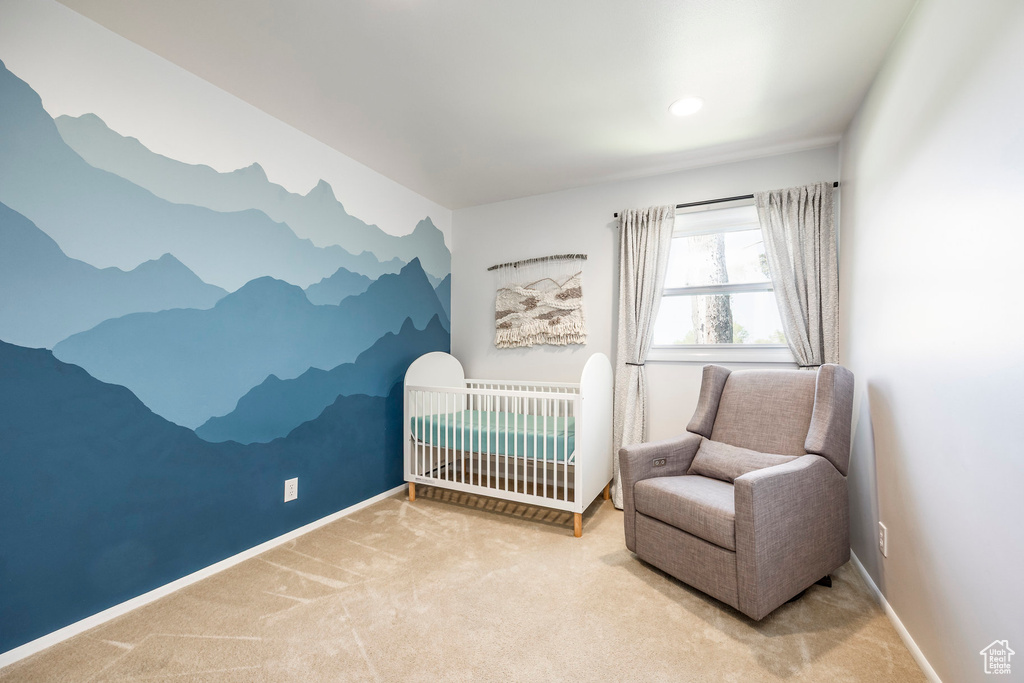 Carpeted bedroom featuring baseboards, a crib, and recessed lighting