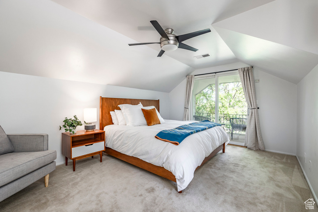 Bedroom with access to outside, vaulted ceiling, light colored carpet, baseboards, and a ceiling fan