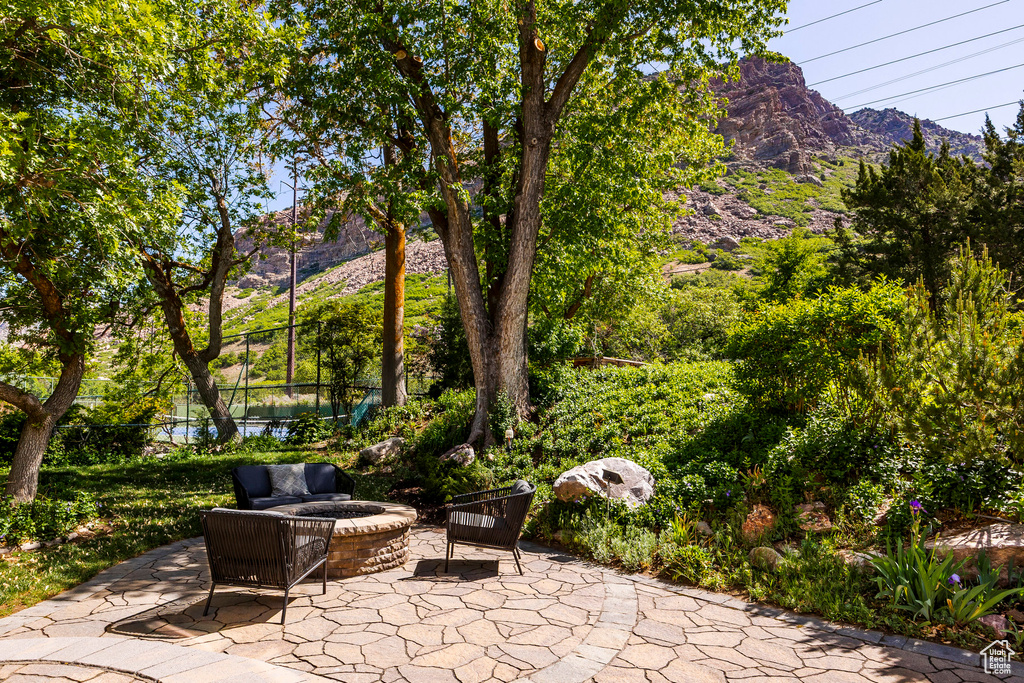 View of patio / terrace with a mountain view and fence