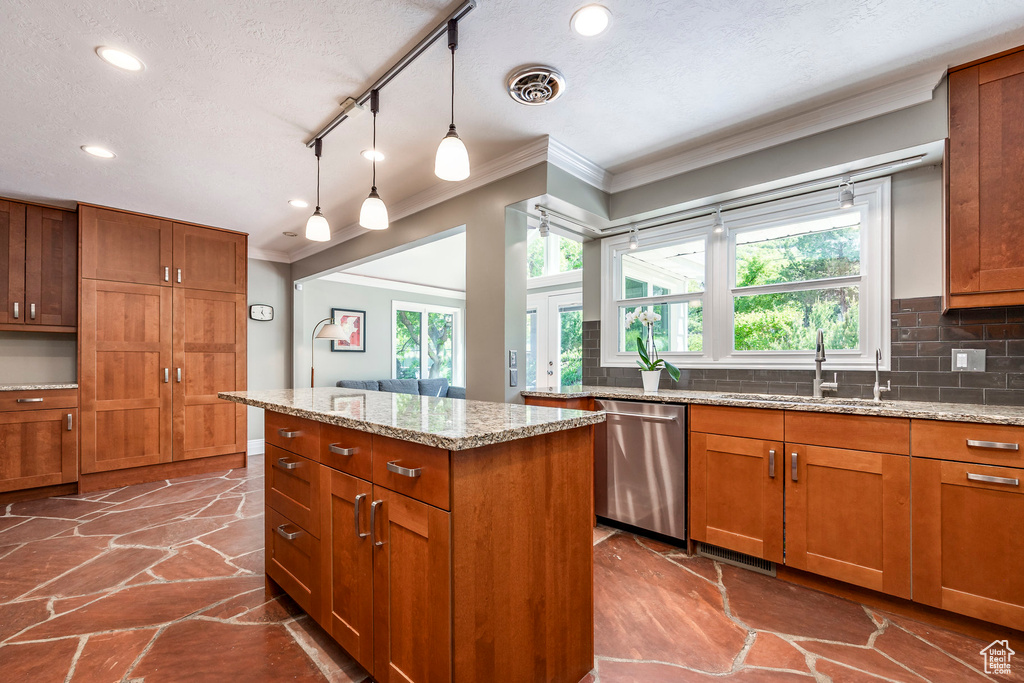 Kitchen featuring crown molding, stainless steel dishwasher, a sink, brown cabinetry, and recessed lighting